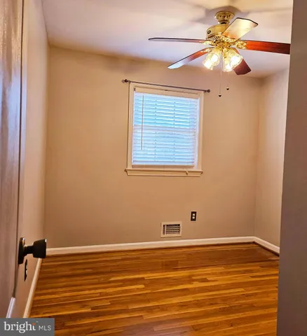 a view of a room with window and wooden floor