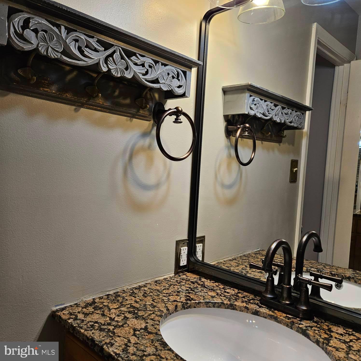 6602 Huntsman Boulevard Springfield, VA 22152 - Photo 10 of 14 a bathroom with a granite countertop sink and a mirror