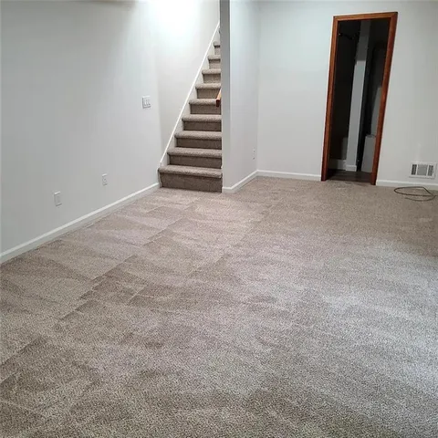 a view of an empty room with stairs