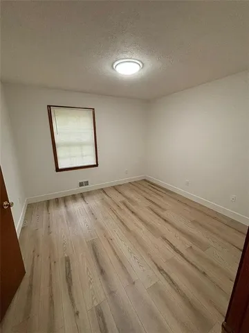 a view of an empty room and wooden floor