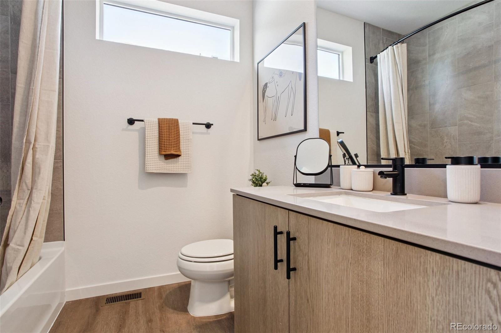 6441 Meade Way Arvada, CO 80003 - Photo 13 of 30 a bathroom with a granite countertop sink mirror vanity and toilet