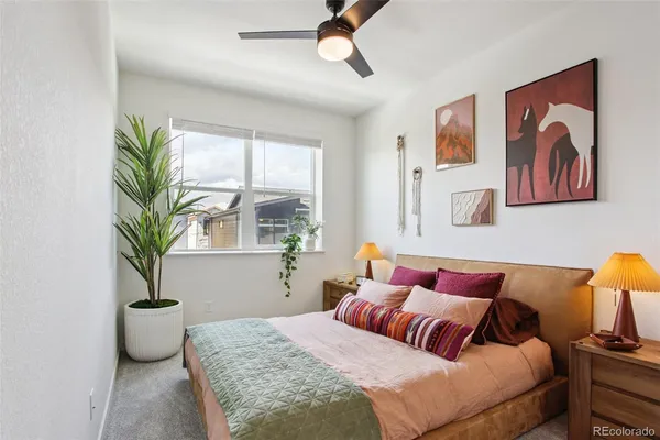 a bedroom with a bed and a potted plant