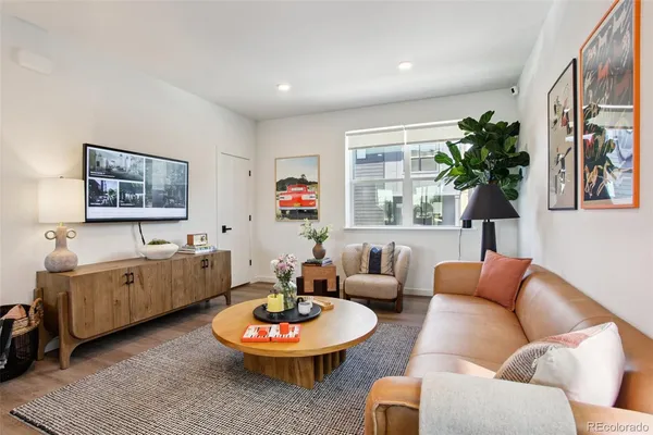 a living room with furniture and a wooden floor