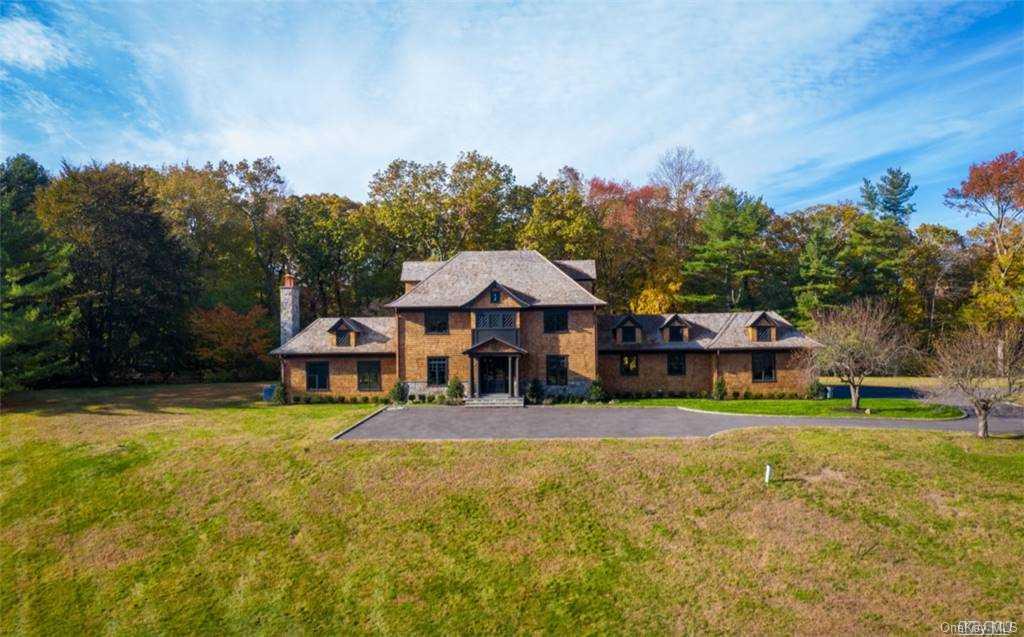 152 Horseshoe Road Mill Neck, NY 11765 - Photo 1 of 1 a front view of a house with a yard table and chairs