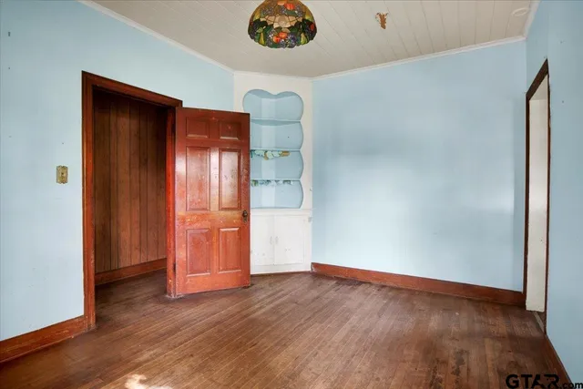 a view of a room with wooden floor and windows
