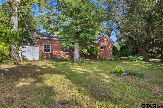 a front view of house with yard and trees
