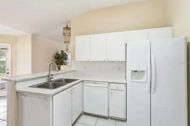 a kitchen with stainless steel appliances white cabinets and a sink