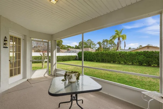 a front view of house with yard and trees in the background