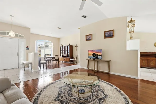 a living room with furniture and a wooden floor