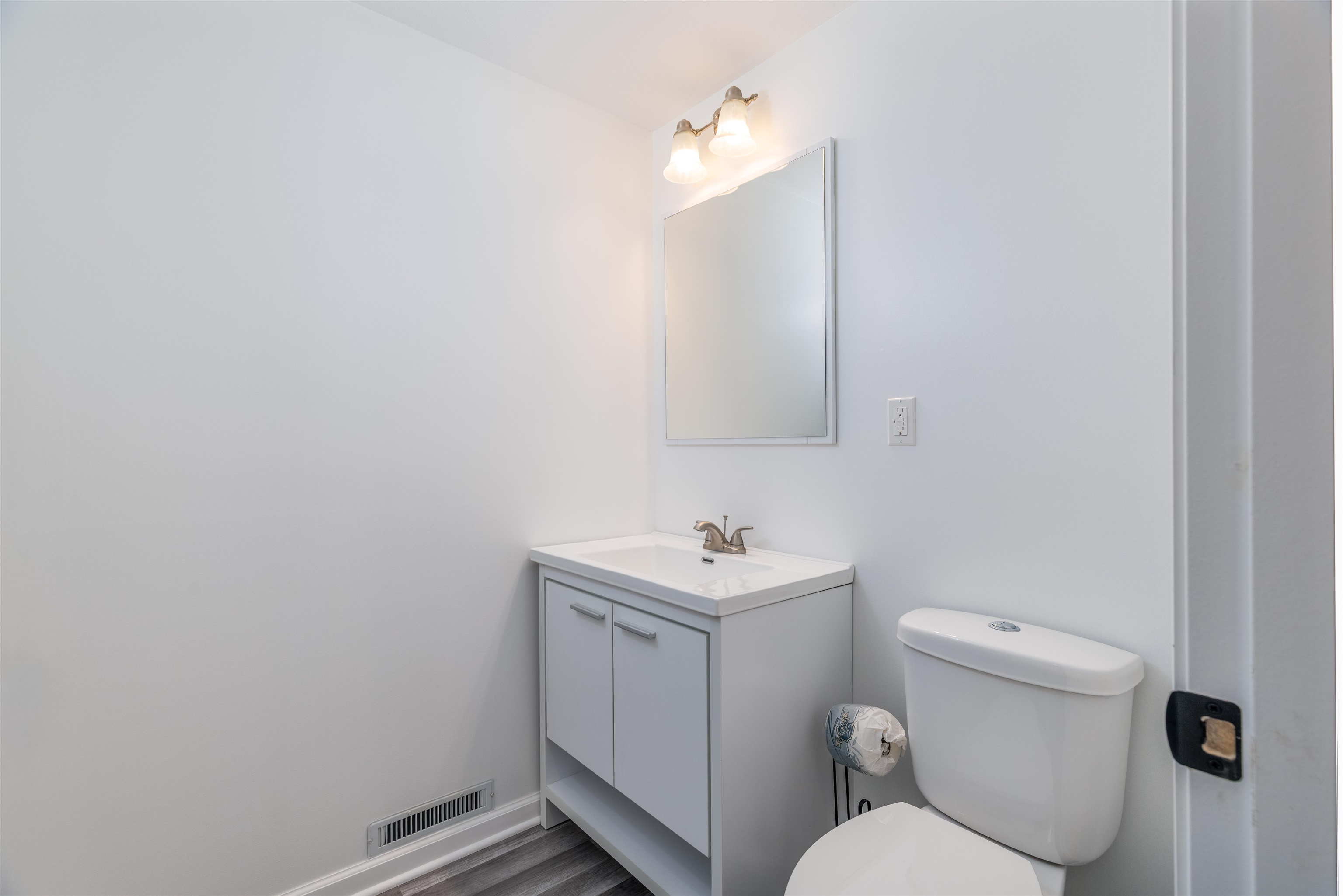 27 Astor Road Babbitt, MN 55706 - Photo 14 of 22 MAin floor 1/4 Bathroom with vanity and dark wood-type flooring