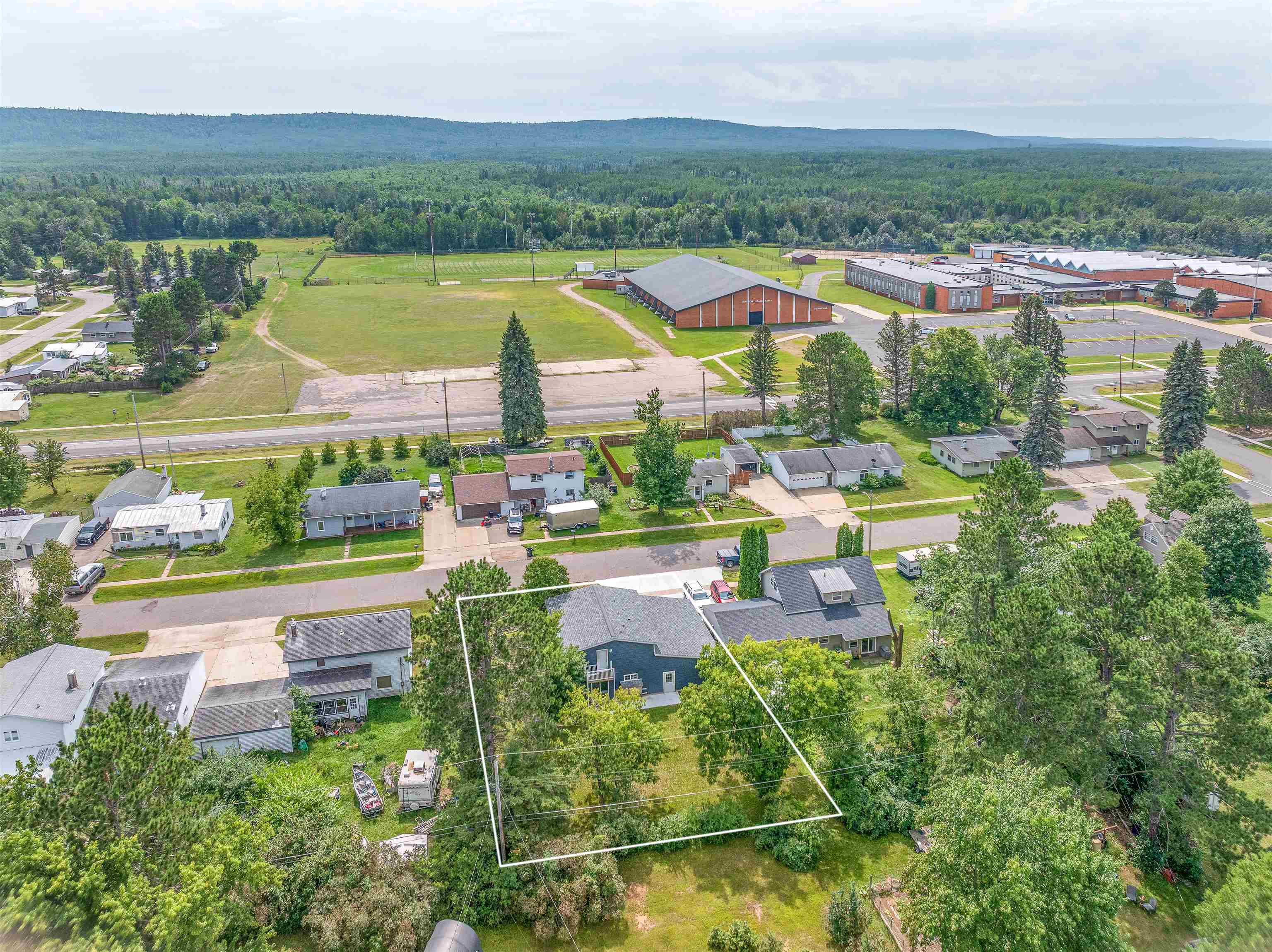 27 Astor Road Babbitt, MN 55706 - Photo 3 of 22 Aerial view of residential area featuring a forest and property boundaries highlighted