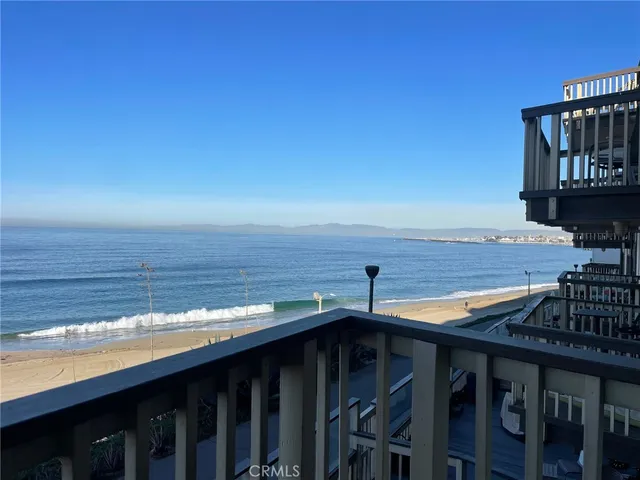 a view of a roof deck with wooden floor and seating space