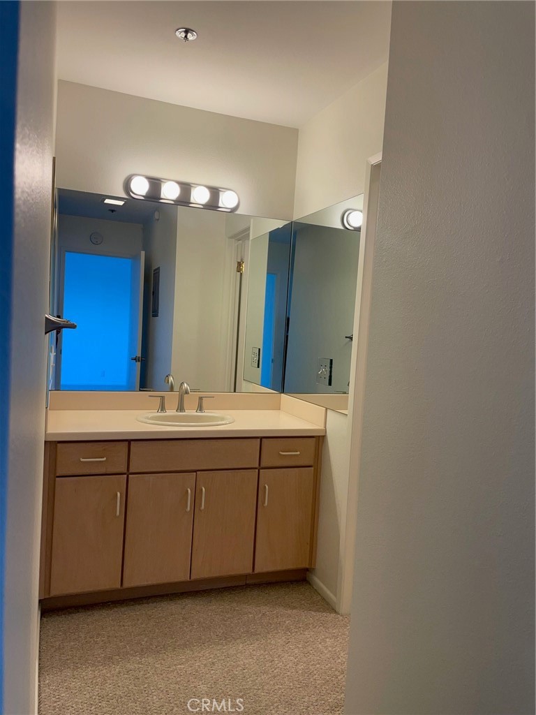 625 Esplanade, Unit 13 Redondo Beach, CA 90277 - Photo 9 of 19 a bathroom with a double vanity sink and a mirror