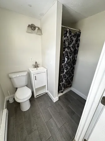 a bathroom with a toilet and a shower