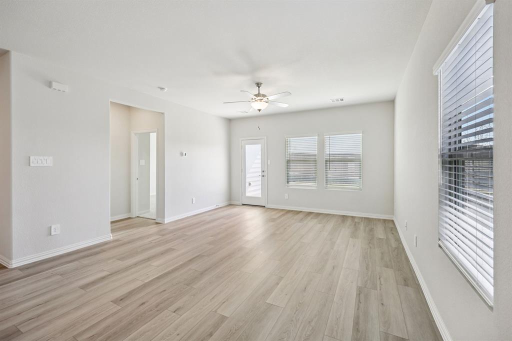 1737 Arches Road Anna, TX 75409 - Photo 12 of 38 wooden floor in an empty room with a window