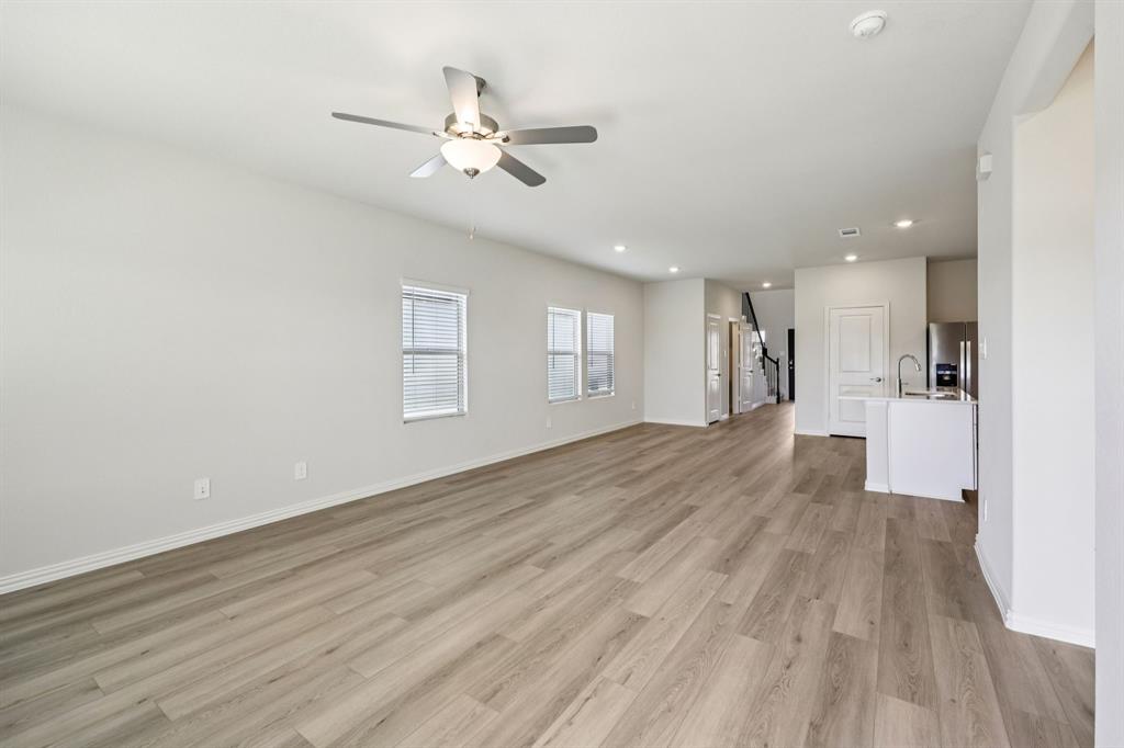 1737 Arches Road Anna, TX 75409 - Photo 15 of 38 a view of a big room with wooden floor and a kitchen