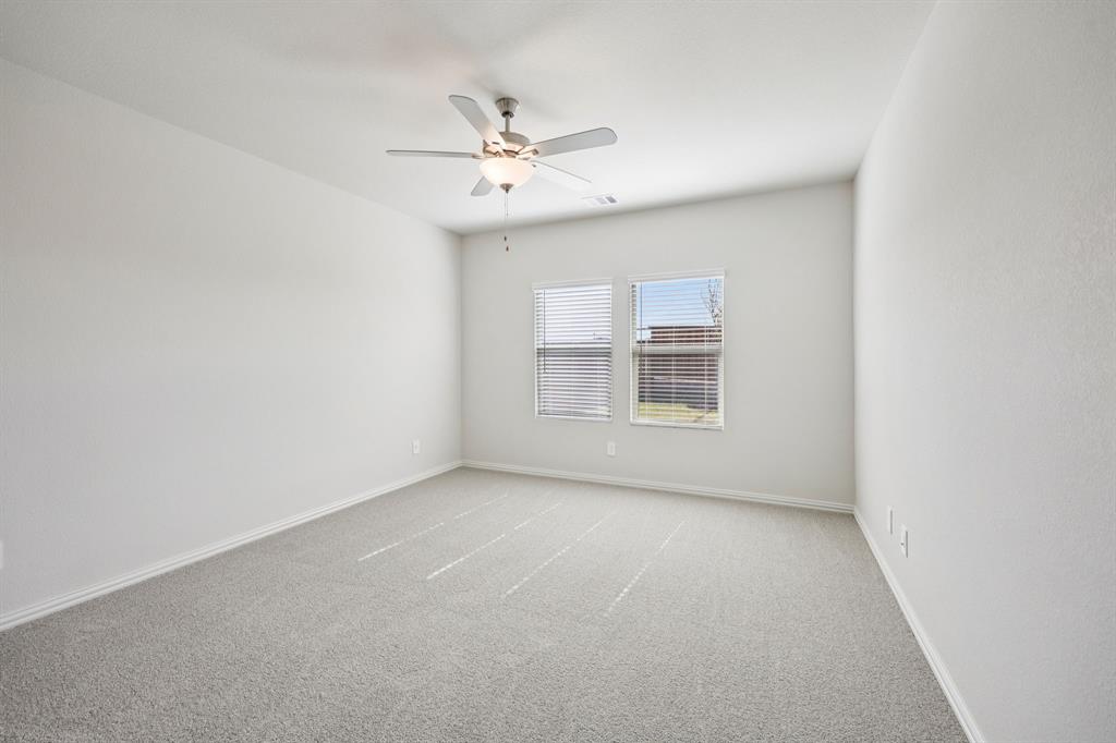 1737 Arches Road Anna, TX 75409 - Photo 17 of 38 an empty room with windows and fan