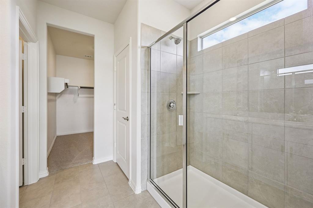 1737 Arches Road Anna, TX 75409 - Photo 32 of 38 a bathroom with a shower and a glass door