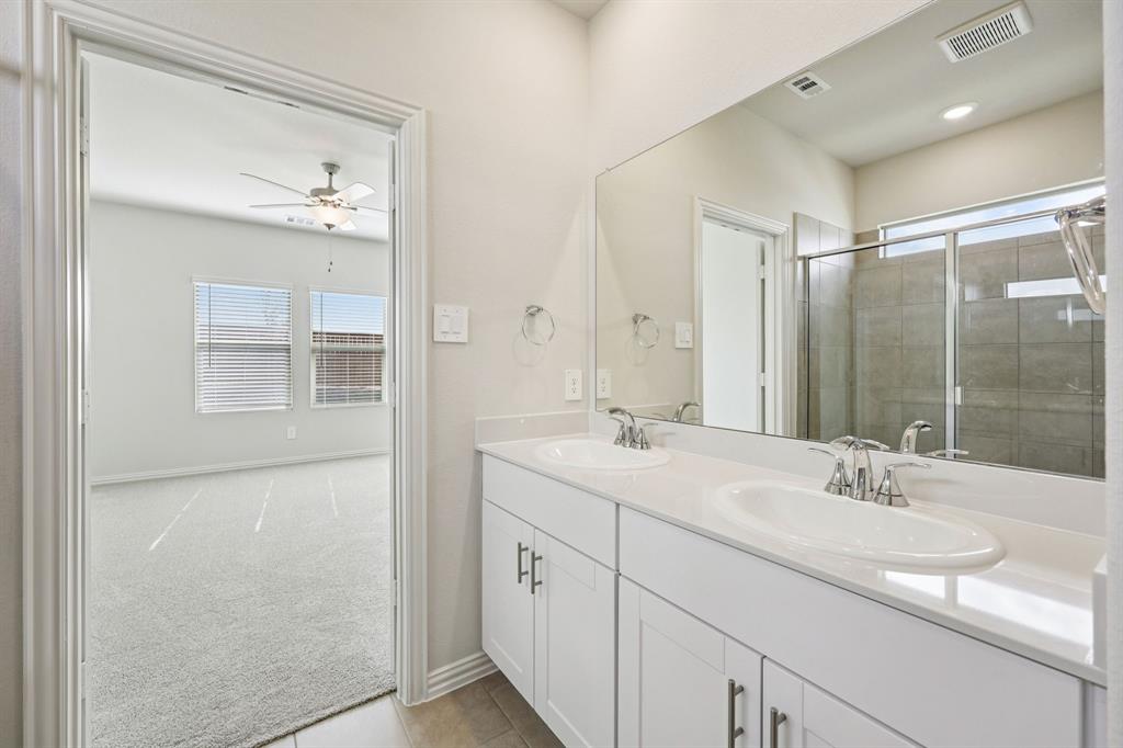 1737 Arches Road Anna, TX 75409 - Photo 33 of 38 a bathroom with a double vanity sink mirror and shower
