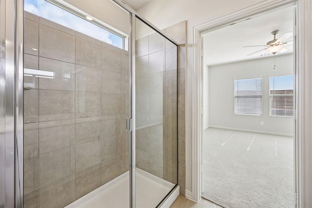 1737 Arches Road Anna, TX 75409 - Photo 34 of 38 a bathroom with a glass shower door