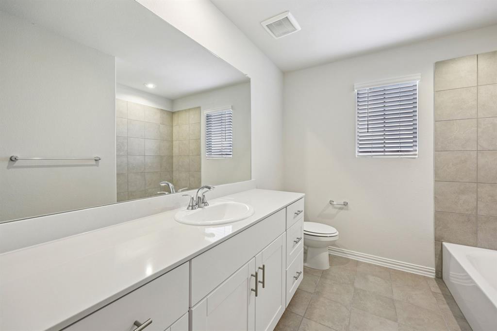 1737 Arches Road Anna, TX 75409 - Photo 35 of 38 a bathroom with a sink a toilet and shower