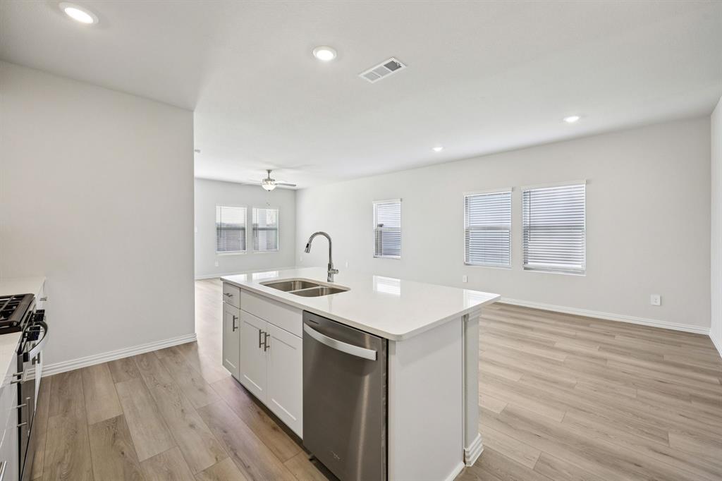 1737 Arches Road Anna, TX 75409 - Photo 5 of 38 a view of a kitchen with sink dishwasher and wooden floor