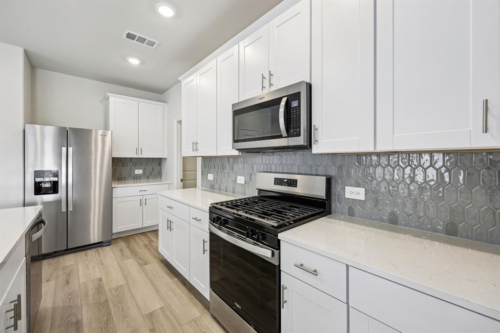1737 Arches Road Anna, TX 75409 - Photo 6 of 38 a kitchen with cabinets stainless steel appliances and a counter space