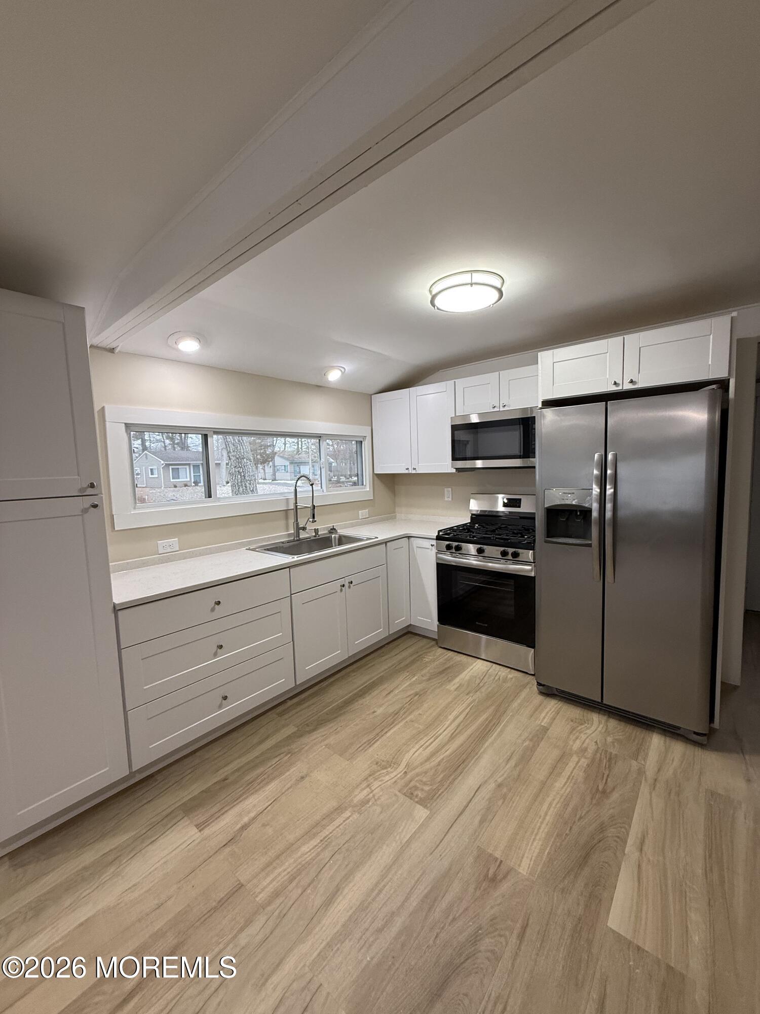 801 Pensacola Road Forked River, NJ 08731 - Photo 13 of 22 a kitchen with granite countertop a refrigerator and a sink