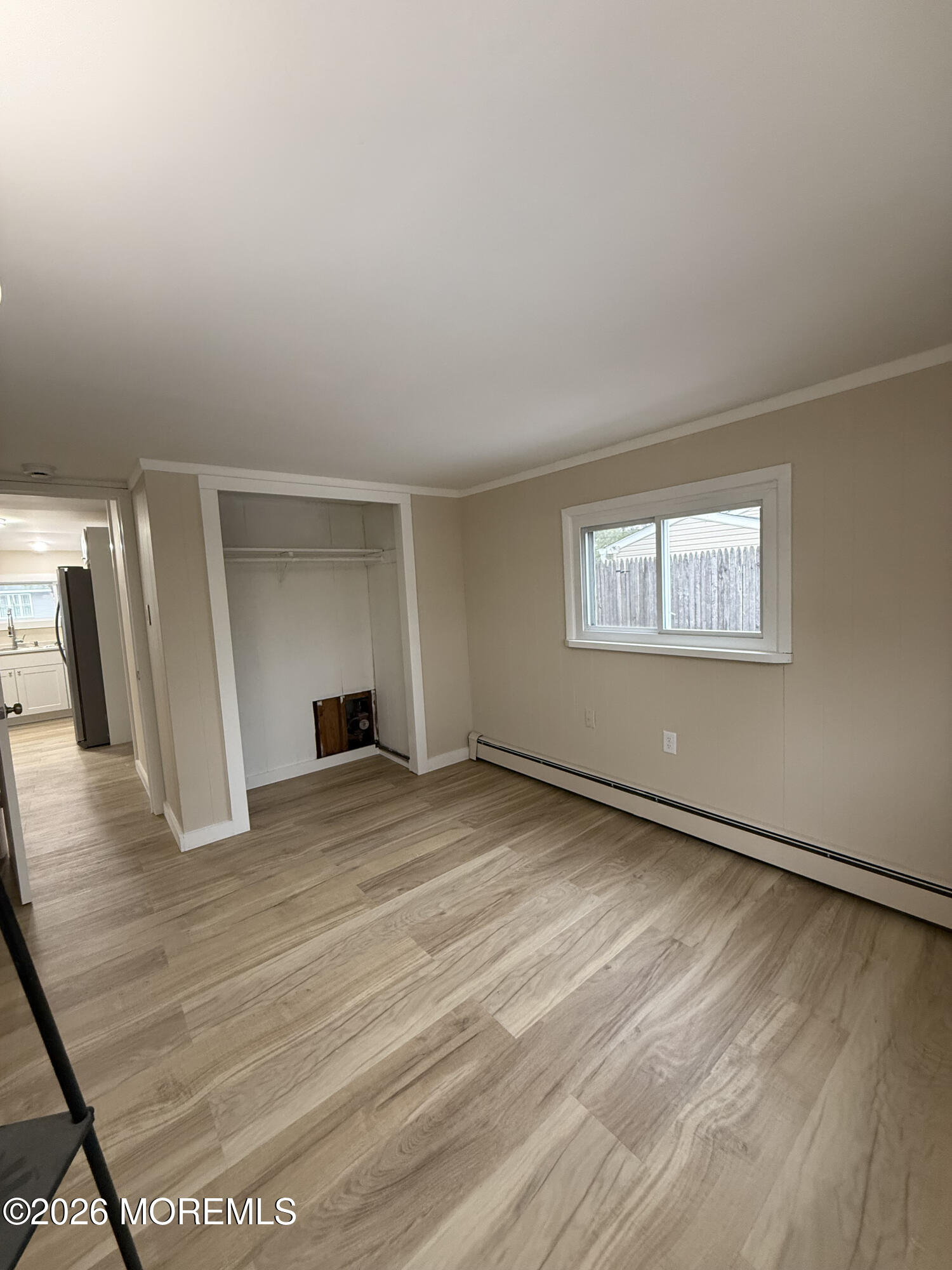 801 Pensacola Road Forked River, NJ 08731 - Photo 21 of 22 a view of an empty room with wooden floor and a window