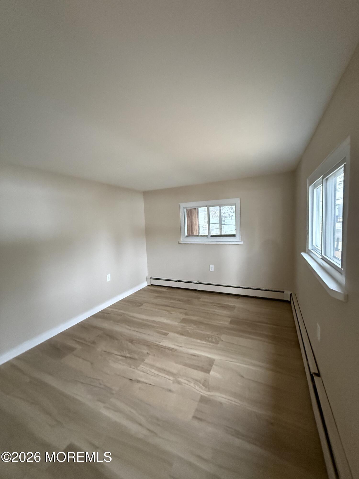 801 Pensacola Road Forked River, NJ 08731 - Photo 3 of 22 an empty room with wooden floor and windows