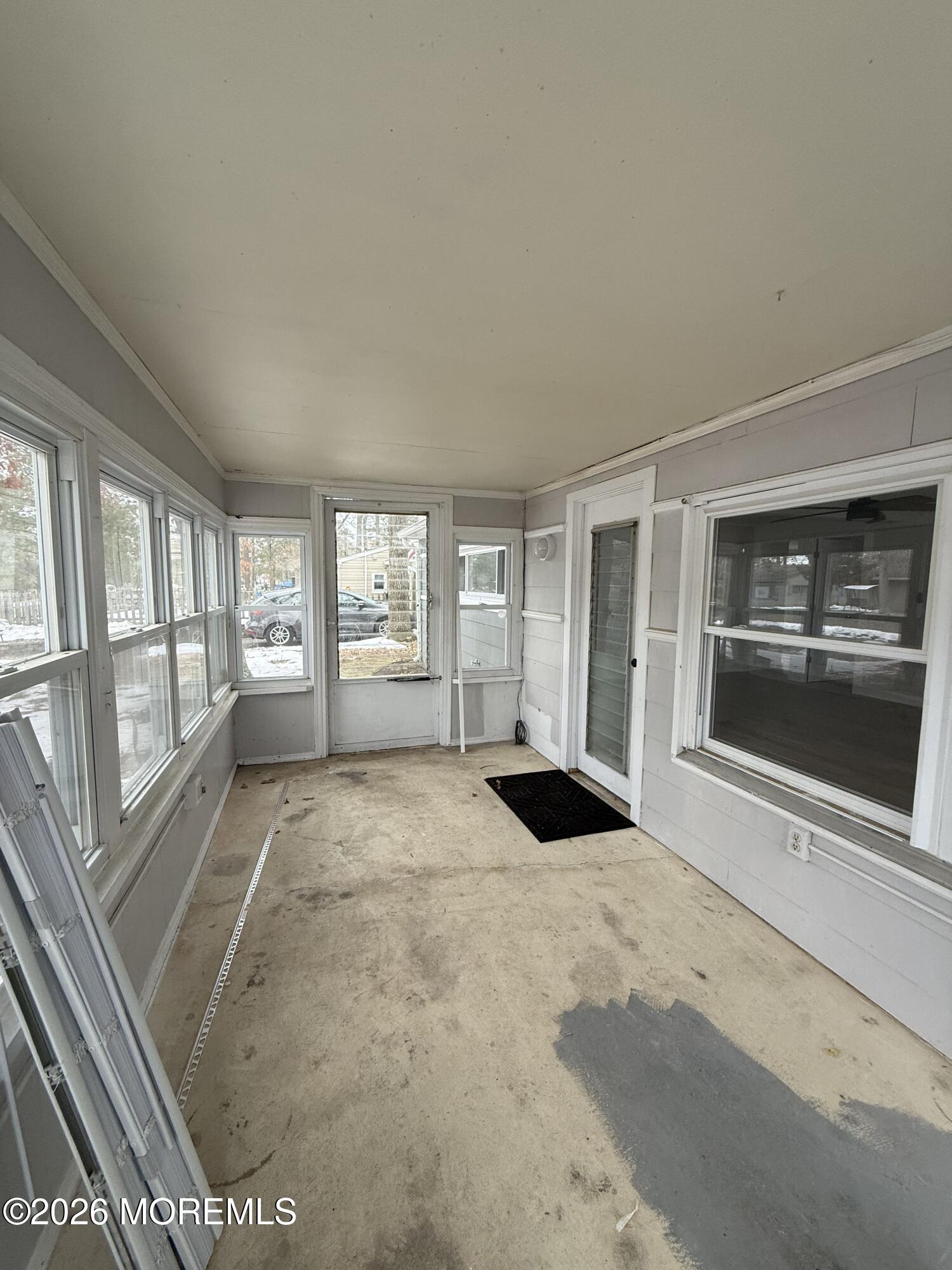 801 Pensacola Road Forked River, NJ 08731 - Photo 7 of 22 a view of an empty room with a fireplace and a window