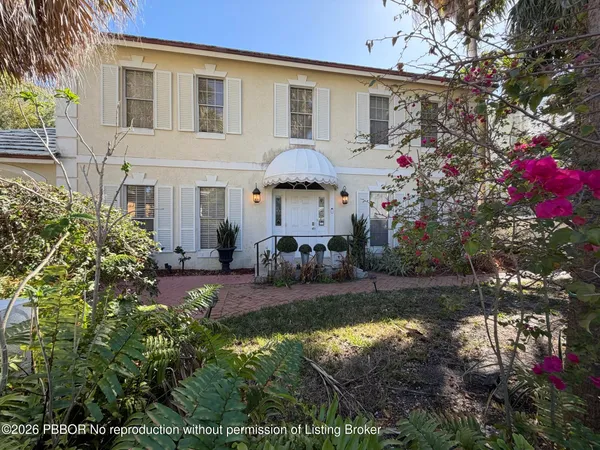a house view with a seating space and garden