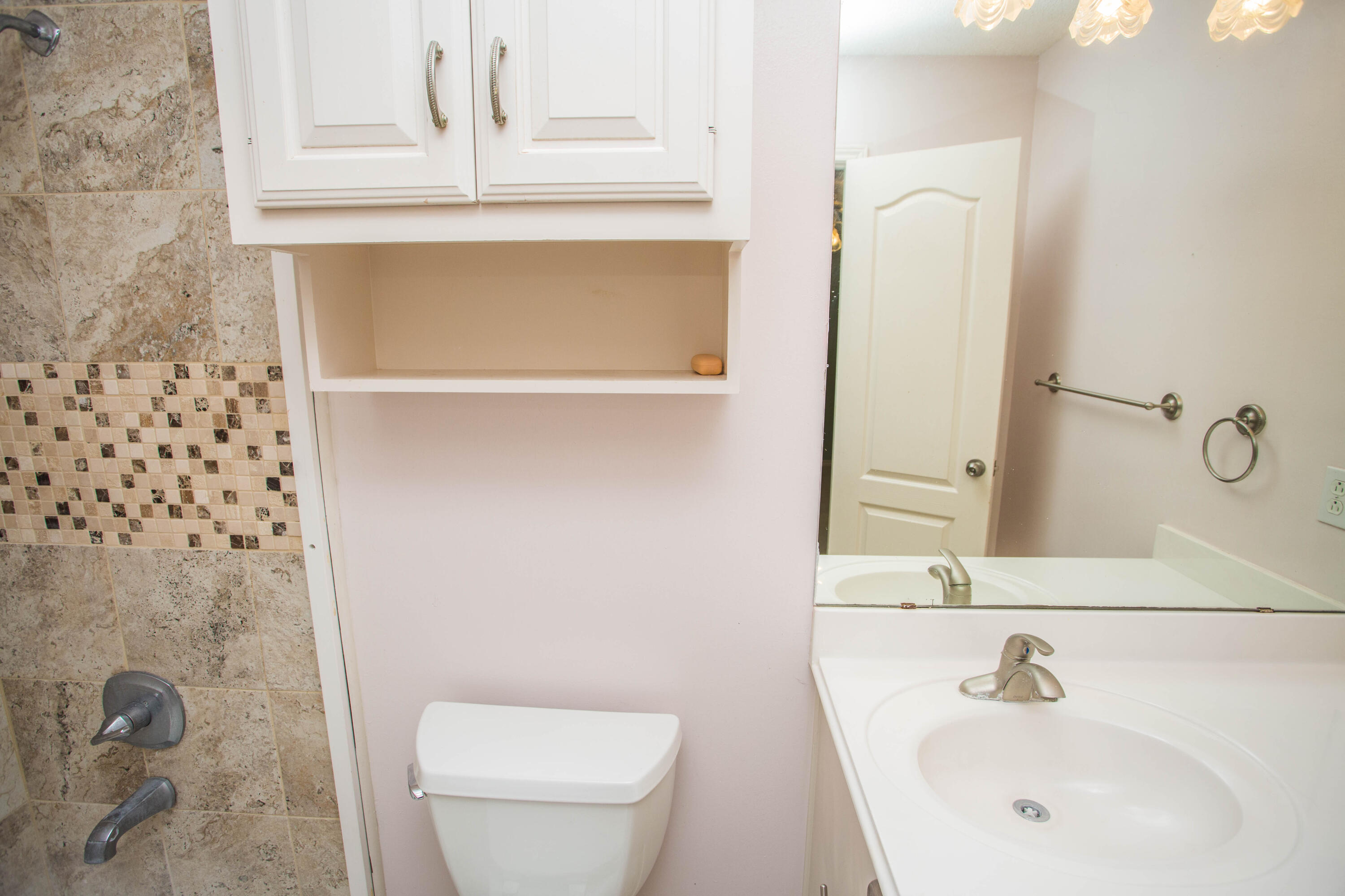 1904 76th Street Lubbock, TX 79423 - Photo 20 of 32 a bathroom with a sink a toilet and shower