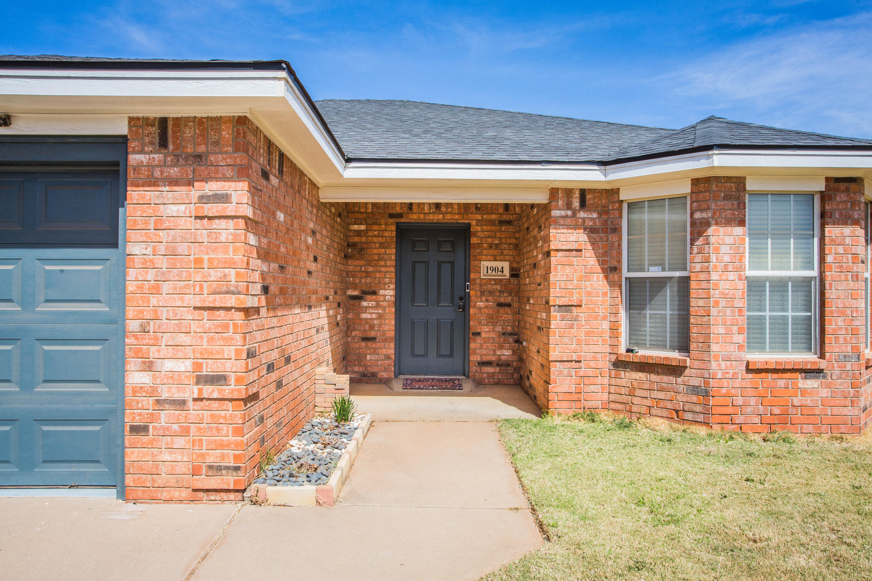 1904 76th Street Lubbock, TX 79423 - Photo 2 of 32 a front view of a house with a garage