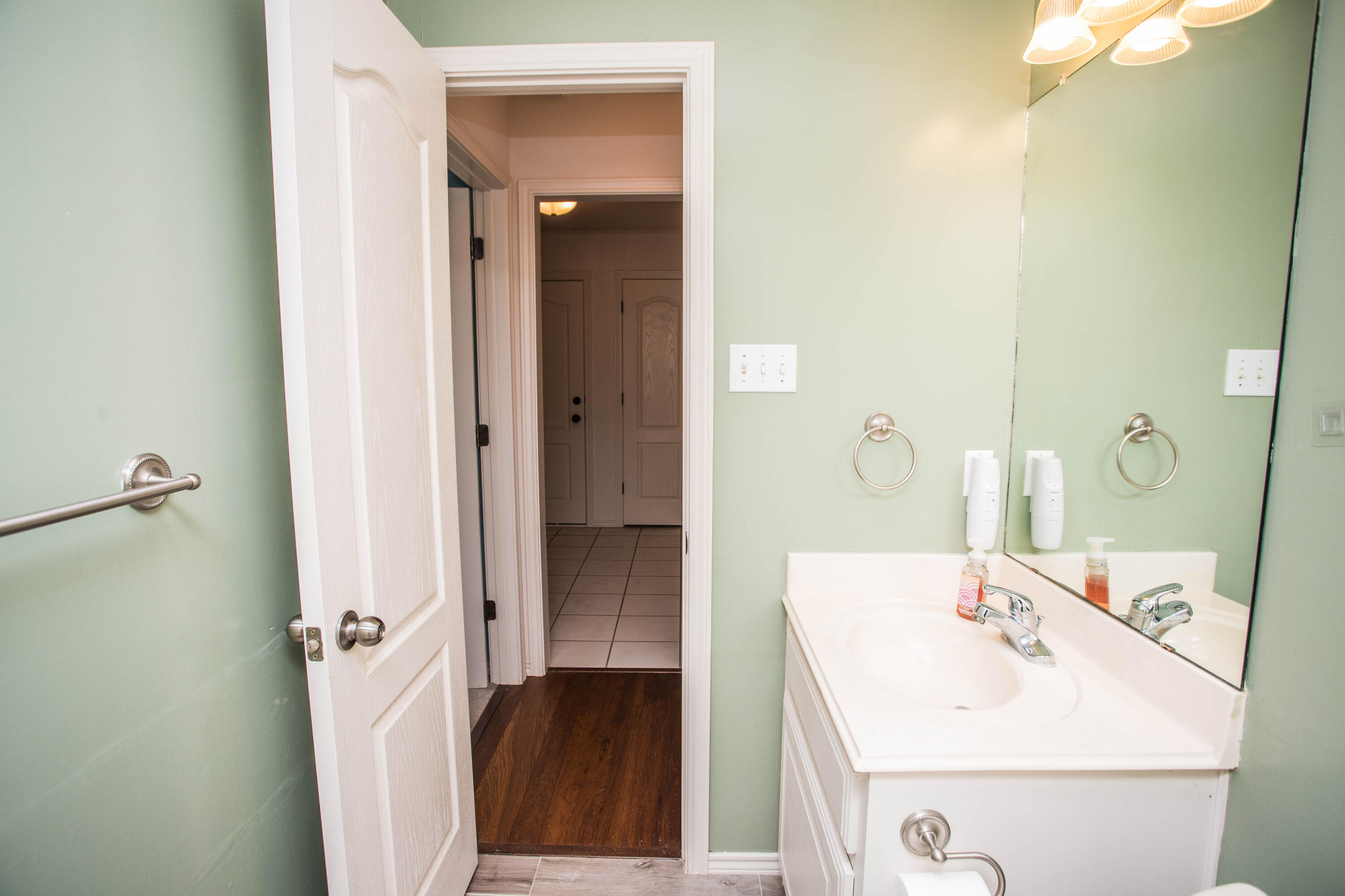 1904 76th Street Lubbock, TX 79423 - Photo 25 of 32 a bathroom with a sink and a mirror