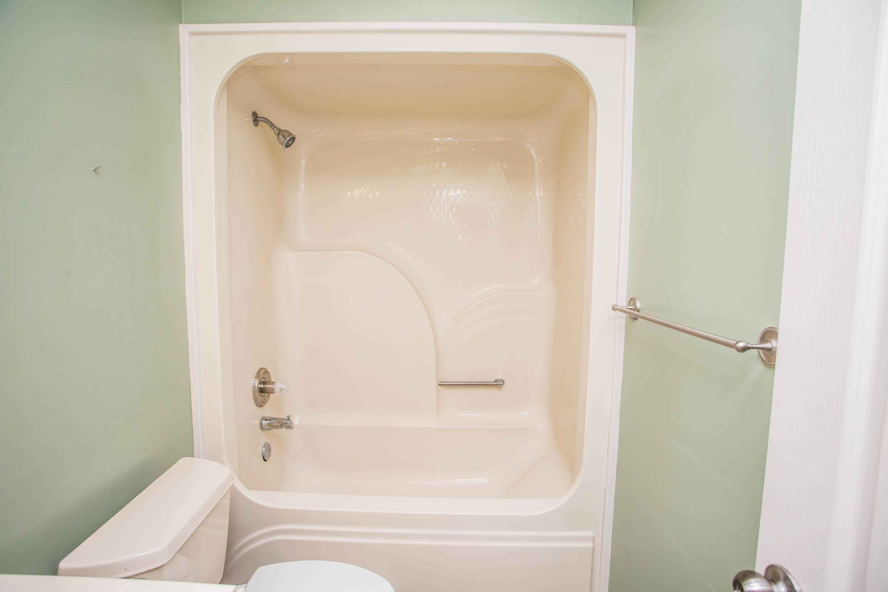 1904 76th Street Lubbock, TX 79423 - Photo 26 of 32 a bathroom with a bathtub and a toilet