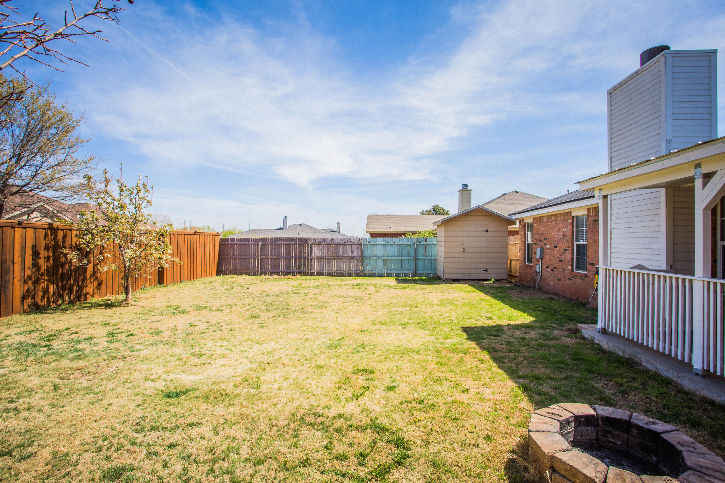1904 76th Street Lubbock, TX 79423 - Photo 31 of 32 a swimming pool with yard and wooden fence