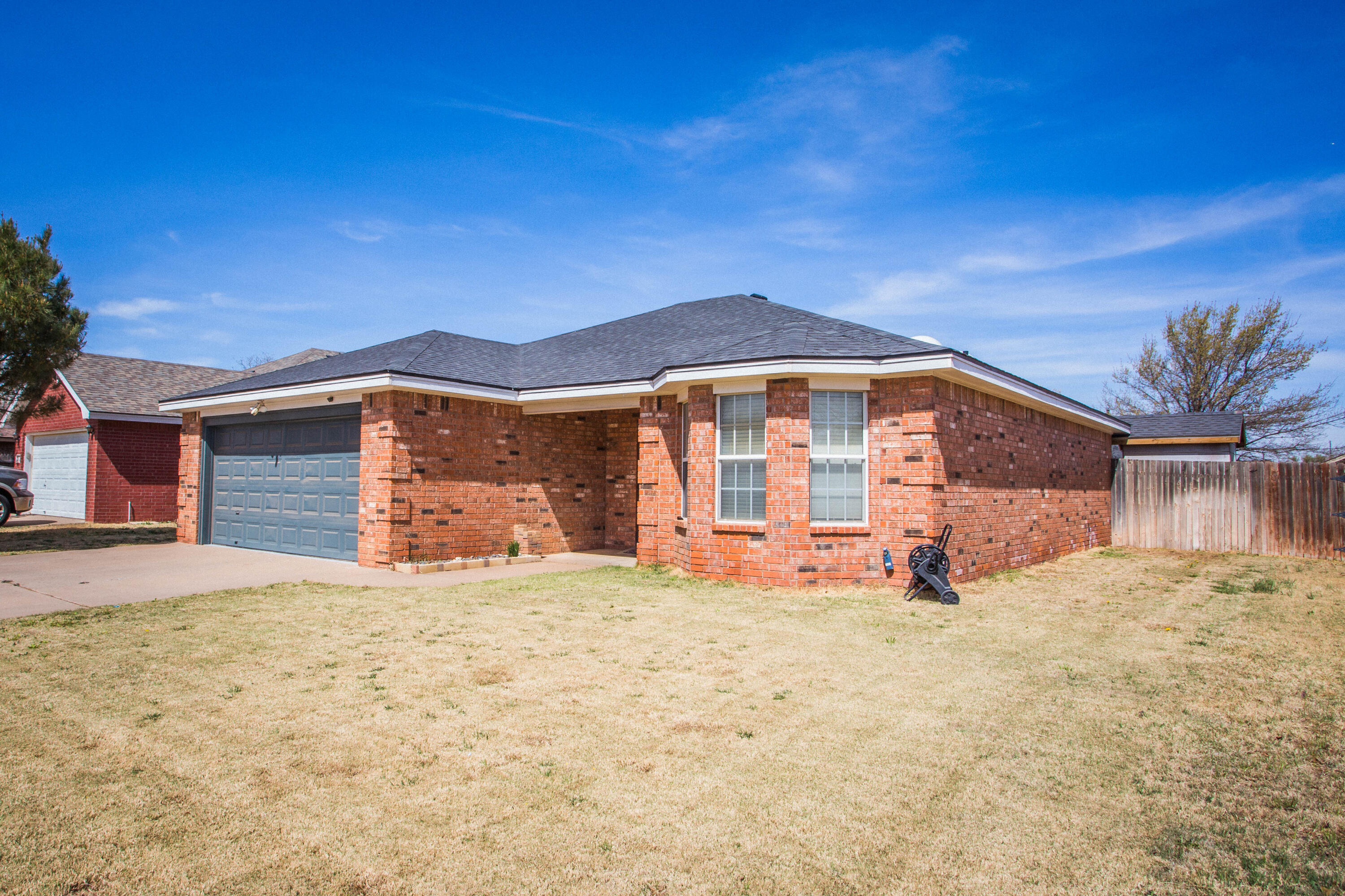 1904 76th Street Lubbock, TX 79423 - Photo 4 of 32 a large house with a big yard and large trees