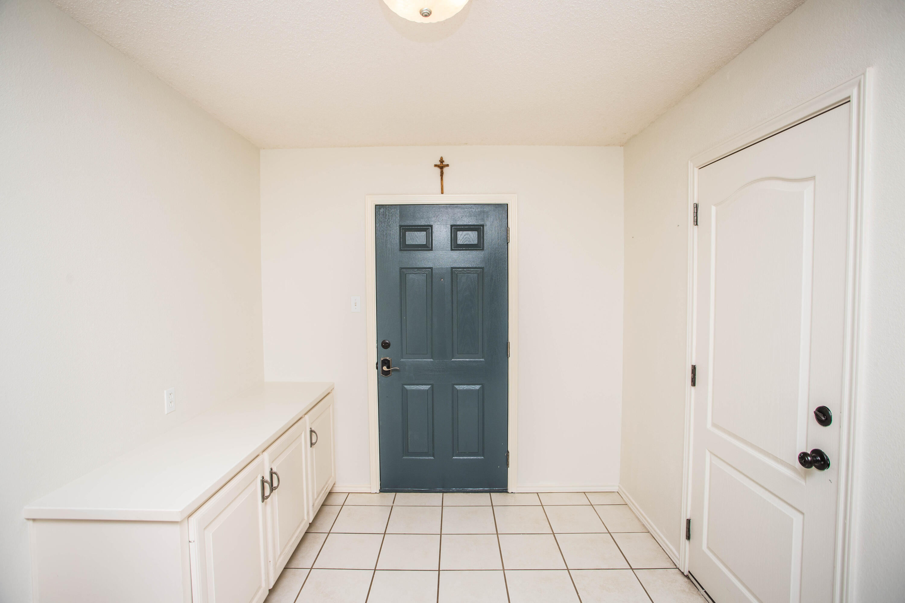 1904 76th Street Lubbock, TX 79423 - Photo 6 of 32 a view of a hallway to the closet and front door