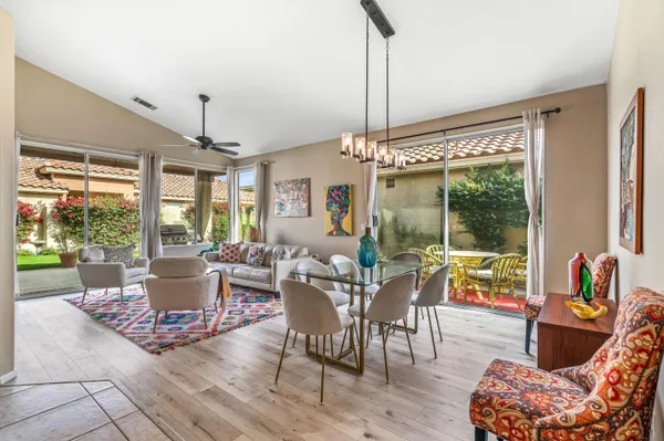 a living room filled with furniture and a chandelier
