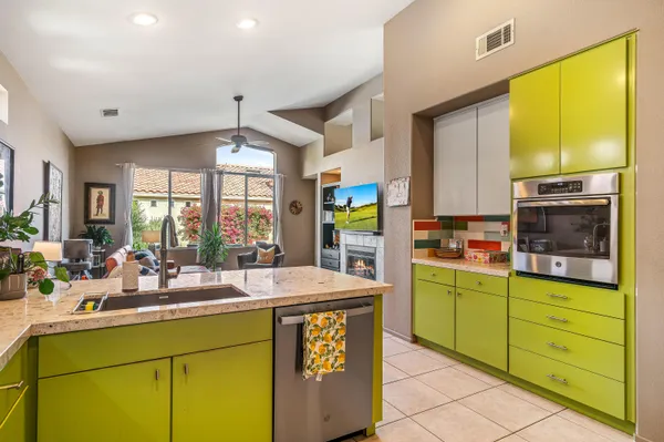 a kitchen that has a sink and a stove in it