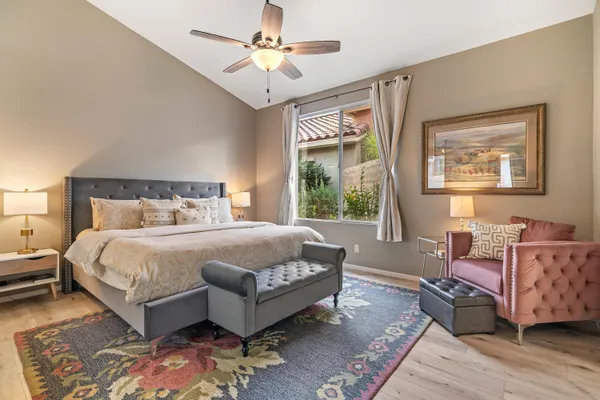 a bedroom with a bed rug and window