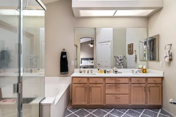 a bathroom with a double vanity sink and a mirror