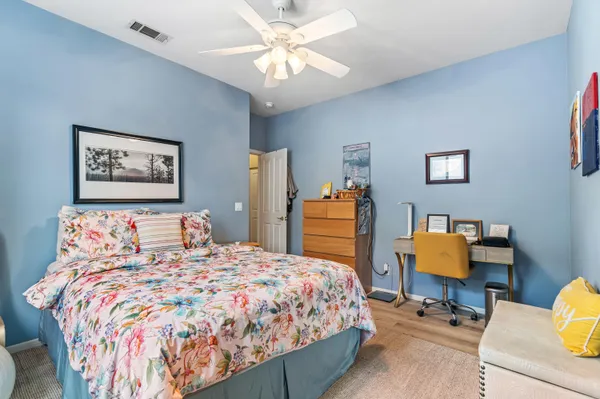 a bedroom with a bed and a chair in it