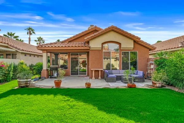 a front view of house with yard and outdoor seating