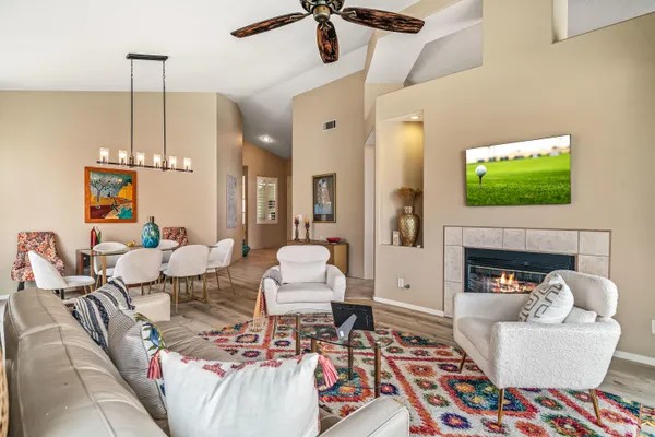 a living room with fireplace a rug and a flat screen tv