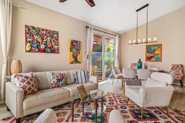 a living room with furniture and a chandelier