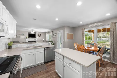 a kitchen that has a sink a stove counter top space and cabinets