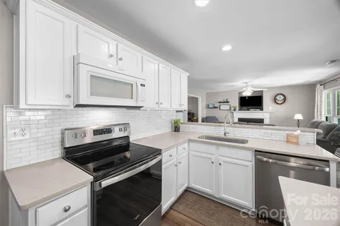 a kitchen with cabinets stainless steel appliances and a sink