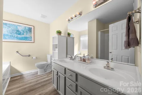 a bathroom with a double vanity sink and a mirror